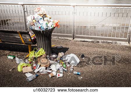Stock Image - Trash overflowing from bin. Fotosearch