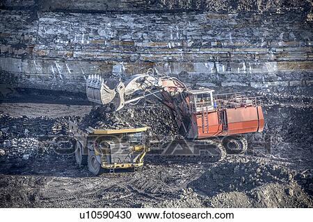Trucks and digger at surface coal mine View Large Photo Image Stock Image - Trucks and digger at surface coal mine. Fotosearch