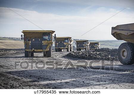 Stock Photography - Trucks with coal rocks at surface mine. Fotosearch