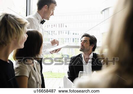 Waiter taking businessmans order View Large Photo Image Stock Photo - Waiter taking businessmans order. Fotosearch