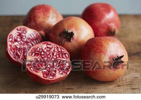 Whole and halved pomegranates View Large Photo Image Stock Image - Whole and halved pomegranates. Fotosearch