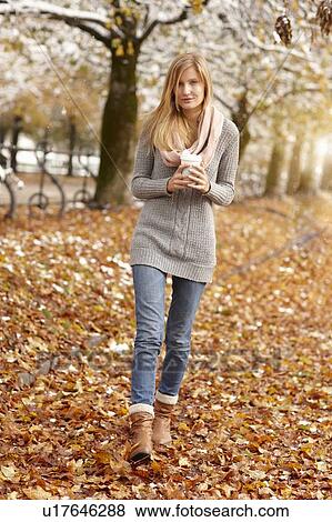 Stock Photo - Woman drinking coffee in winter forest. Fotosearch