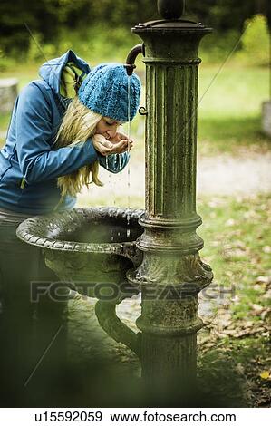 Woman drinking from water fountain View Large Photo Image Stock Photo - Woman drinking from water fountain. Fotosearch