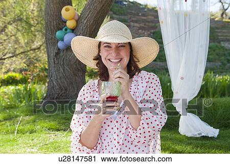 Woman drinking juice outdoors View Large Photo Image Stock Image - Woman drinking juice outdoors. Fotosearch