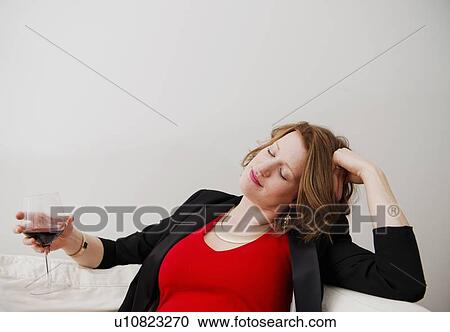 Woman drinking wine on sofa View Large Photo Image Stock Image - Woman drinking wine on sofa. Fotosearch