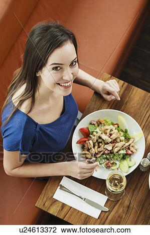 Woman having lunch at cafe View Large Photo Image Stock Image - Woman having lunch at cafe. Fotosearch