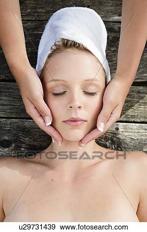 Woman having massage on wooden deck View Large Photo Image Stock Photo - Woman having massage on wooden deck. Fotosearch