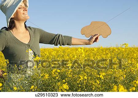 Woman holding car shape outdoors View Large Photo Image Stock Image - Woman holding car shape outdoors. Fotosearch