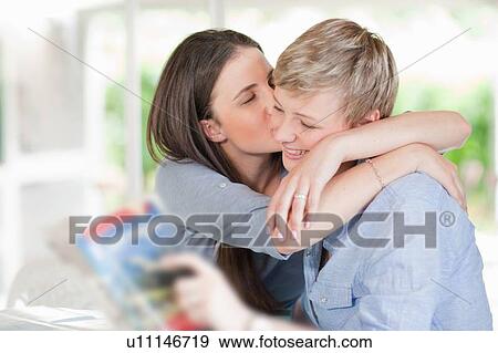 Woman kissing smiling girlfriend View Large Photo Image Stock Photo - Woman kissing smiling girlfriend. Fotosearch