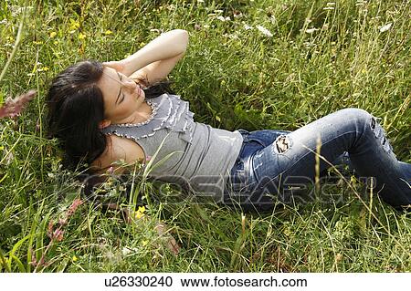 Woman laying in tall grass View Large Photo Image Stock Image - Woman laying in tall grass. Fotosearch