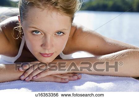 Woman laying on towel outdoors View Large Photo Image Stock Photograph - Woman laying on towel outdoors. Fotosearch