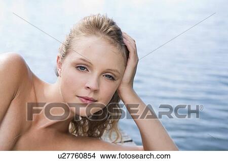 Woman laying on wooden dock View Large Photo Image Picture - Woman laying on wooden dock. Fotosearch