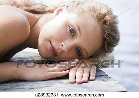 Woman laying on wooden dock View Large Photo Image Stock Image - Woman laying on wooden dock. Fotosearch