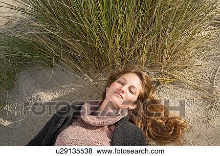 Woman napping on beach View Large Photo Image Stock Photo - Woman napping on beach. Fotosearch