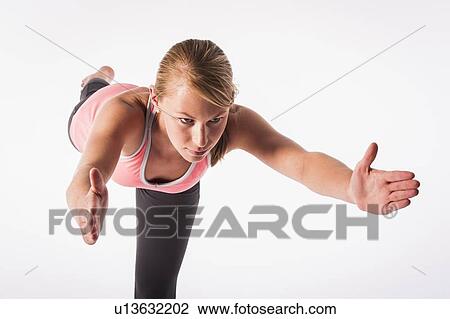 Stock Image - Woman practicing yoga. Fotosearch