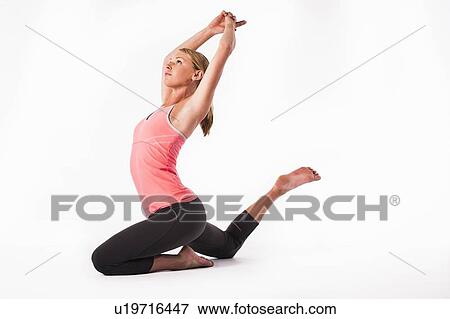 Stock Photo - Woman practicing yoga. Fotosearch