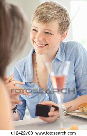 Stock Image - Woman proposing to girlfriend. Fotosearch