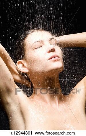 Stock Image - Woman rinsing her hair in shower. Fotosearch