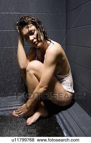 Stock Photo - Woman showering in shirt. Fotosearch
