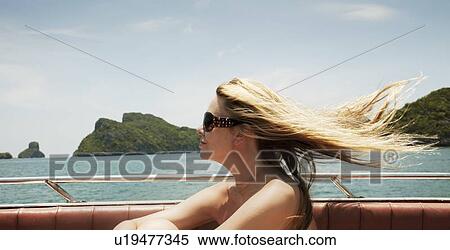 Woman sitting in boat on lake View Large Photo Image Stock Photography - Woman sitting in boat on lake. Fotosearch