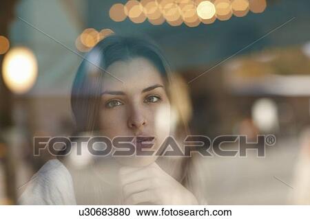 Stock Image - Woman smiling behind window. Fotosearch