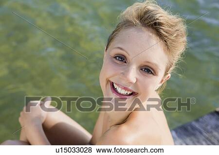 Woman smiling by still lake View Large Photo Image Stock Photo - Woman smiling by still lake. Fotosearch