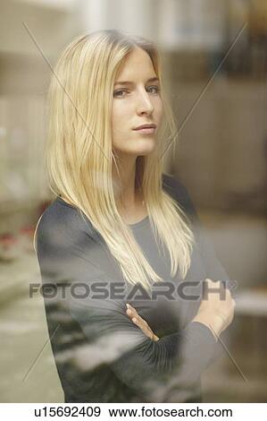 Stock Photo - Woman standing behind window. Fotosearch