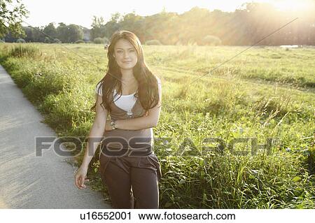 Woman standing on rural road View Large Photo Image Stock Image - Woman standing on rural road. Fotosearch