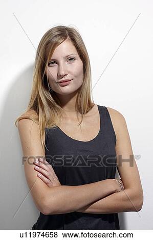 Stock Photo - Woman standing with arms crossed. Fotosearch