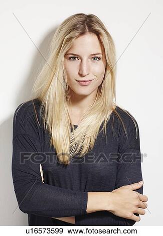 Stock Photo - Woman standing with arms crossed. Fotosearch