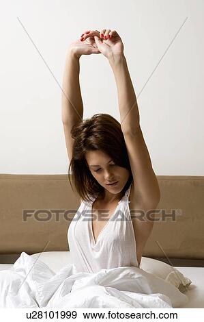 Woman stretching in bed View Large Photo Image Stock Photo - Woman stretching in bed. Fotosearch