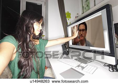 Stock Image - Woman taking picture with video chat. Fotosearch
