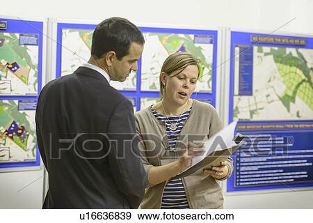 Woman talking with town hall staff View Large Photo Image Stock Photo - Woman talking with town hall staff. Fotosearch