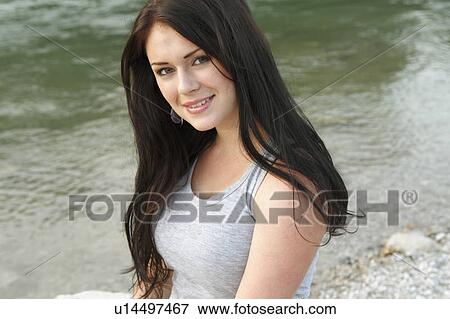 Woman walking on rocky beach View Large Photo Image Stock Photo - Woman walking on rocky beach. Fotosearch