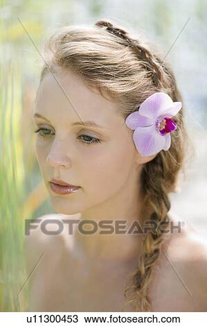 Woman wearing flower in her hair View Large Photo Image Stock Image - Woman wearing flower in her hair. Fotosearch
