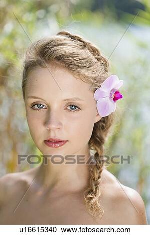 Woman wearing flower in her hair View Large Photo Image Stock Image - Woman wearing flower in her hair. Fotosearch