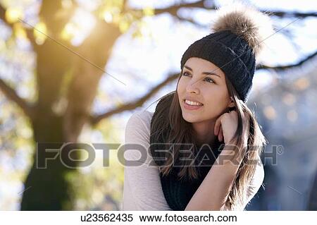 Stock Photography - Woman wearing knitted hat outdoors. Fotosearch