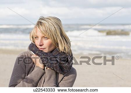 Woman wearing scarf on beach View Large Photo Image Stock Image - Woman wearing scarf on beach. Fotosearch