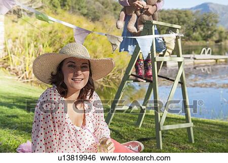 Woman wearing sun hat outdoors View Large Photo Image Stock Photograph - Woman wearing sun hat outdoors. Fotosearch