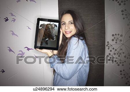 Picture - Woman with dog on tablet computer. Fotosearch