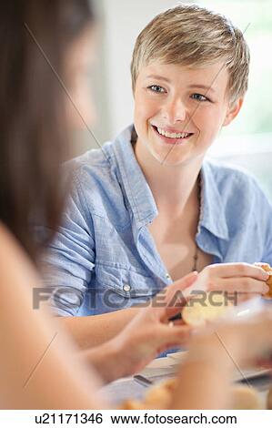 Women eating breakfast together View Large Photo Image Stock Photograph - Women eating breakfast together. Fotosearch