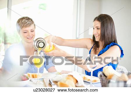 Stock Photo - Women having breakfast together. Fotosearch