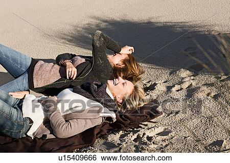 Women laughing on beach View Large Photo Image Stock Photograph - Women laughing on beach. Fotosearch