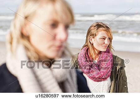 Women standing on beach View Large Photo Image Stock Photo - Women standing on beach. Fotosearch