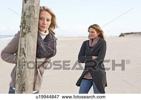 Women standing on beach View Large Photo Image Stock Photo - Women standing on beach. Fotosearch