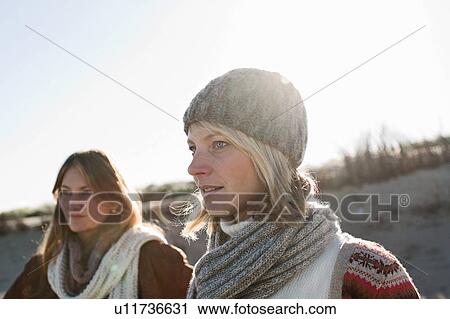 Women walking together on beach View Large Photo Image Stock Image - Women walking together on beach. Fotosearch