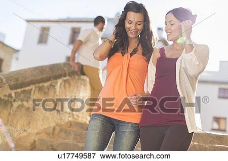 Stock Photo - Women walking together on city street. Fotosearch