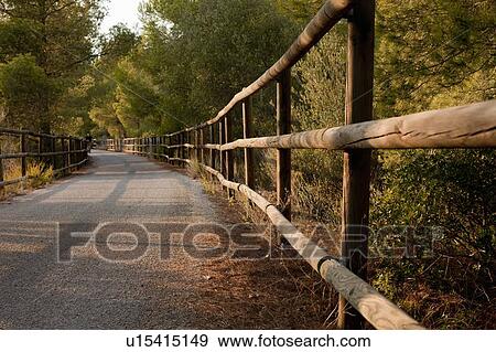 Wooden fence along dirt road View Large Photo Image Stock Photo - Wooden fence along dirt road. Fotosearch