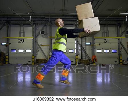 Worker balancing boxes in warehouse View Large Photo Image Stock Image - Worker balancing boxes in warehouse. Fotosearch