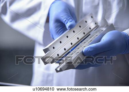 Stock Image - Worker cleaning with ultrasonics. Fotosearch